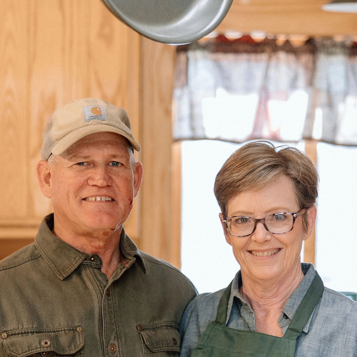 Mark and Becca Sperry standing together in their home kitchen.